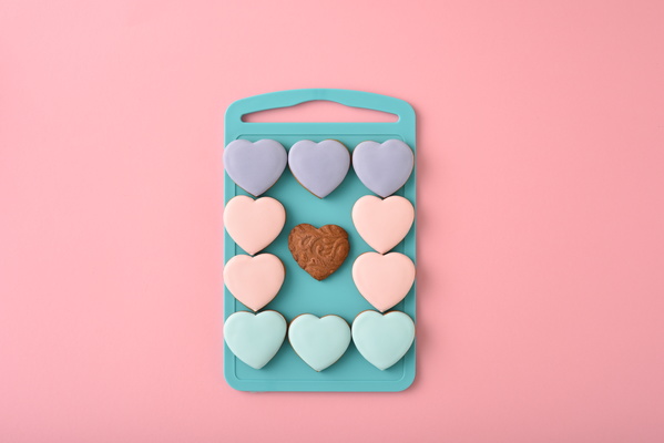 Some Multicolored Heart-Shaped Cookies Lie on Chopping Board